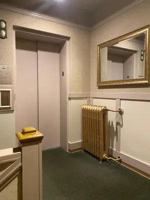 a room with a radiator and a mirror on the wall at Kingston Hotel in Vancouver
