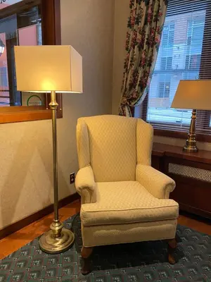 a living room with a chair and a lamp at Kingston Hotel in Vancouver