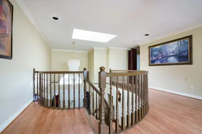 a hallway with a spiral staircase in a home at Fraser River Richmond Bed and Breakfast in Richmond