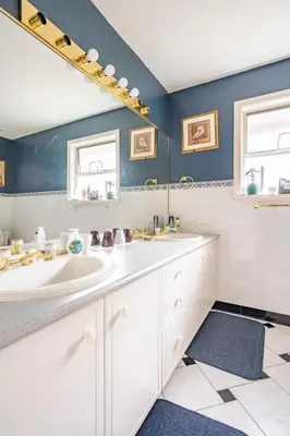 a bathroom with a sink and a mirror at Fraser River Richmond Bed and Breakfast in Richmond