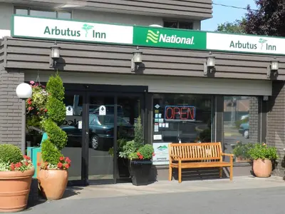 a store front with a bench in front of it at Arbutus Inn in Victoria