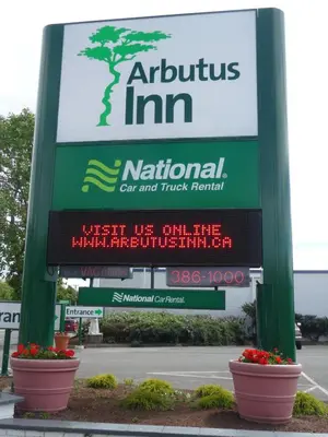 a sign for a national car and truck rental at Arbutus Inn in Victoria