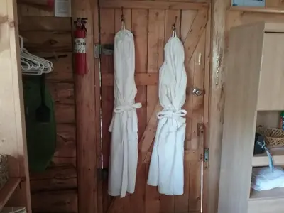 two white towels hanging on a wall in a cabin at Eagle Bear Lodge in Tatla Lake