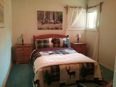 a bedroom with a bed and a deer blanket at Eagle Bear Lodge in Tatla Lake