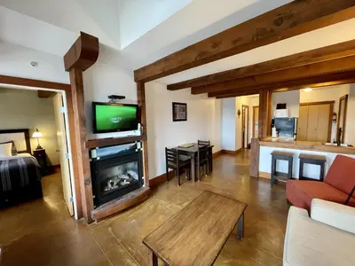 a living room with a fireplace and a tv at Great Condo In Excellent Location - Waterfront Building - Seaside in Ucluelet