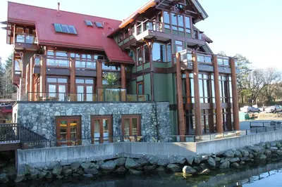 a large house on top of a body of water at Great Condo In Excellent Location - Waterfront Building - Seaside in Ucluelet