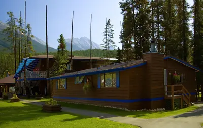 a small house with a blue stripe on it at Sunwapta Falls Rocky Mountain Lodge in Jasper