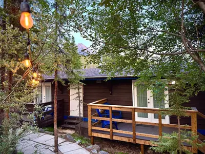 a cabin with a large deck in front of it at Sunwapta Falls Rocky Mountain Lodge in Jasper