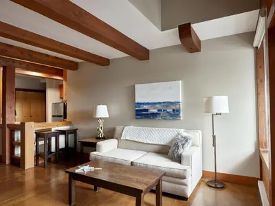 a living room with a white couch and a table at Beautiful Condo In A Great Location, Oceanfront Complex - Oe in Ucluelet