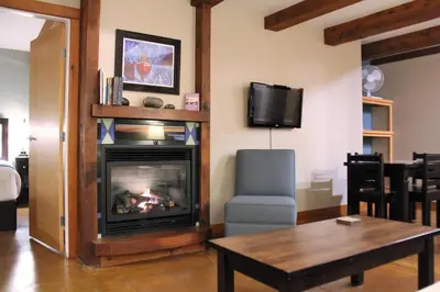 a living room with a fireplace and a table at Beautiful Condo In A Great Location, Oceanfront Complex - Oe in Ucluelet