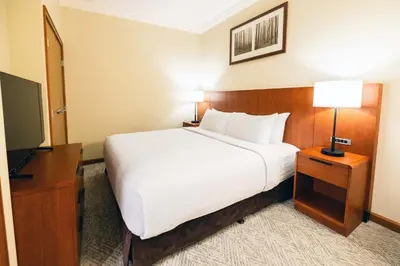 a hotel room with a bed and a flat screen tv at Sutton Place Hotel Revelstoke Mountain Resort in Revelstoke