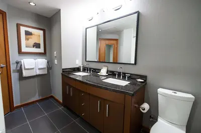 a bathroom with a sink and a mirror at Sutton Place Hotel Revelstoke Mountain Resort in Revelstoke