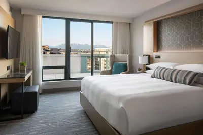 a hotel room with a large bed and a large window at Vancouver Airport Marriott Hotel in Richmond