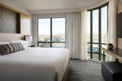 a hotel room with two beds and a large window at Vancouver Airport Marriott Hotel in Richmond