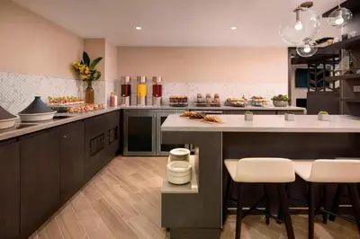 a large kitchen with a large island with bar stools at Vancouver Airport Marriott Hotel in Richmond
