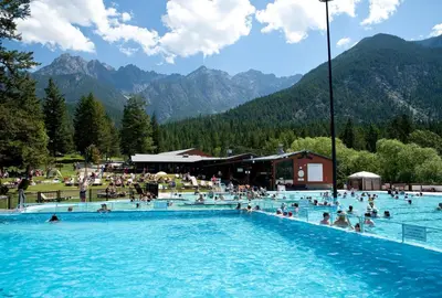 a group of people swimming in a swimming pool at Invermere 4 Br Lakeside, Mountain View Home! Walk to Sandy Beach for Swimming, Boating, Tennis and Beach Volleyball Local Town Shopping, Eateries, Bakery and Pubs! Welcome Family's, Healthcare Workers and Trades! Monthly Rentals of 28 Nights or More! in Invermere