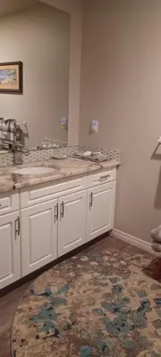 a kitchen with white cabinets and a rug at Deer Ridge B&B in Golden