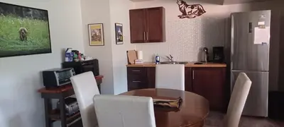 a kitchen with a table and a kitchen with a refrigerator at Deer Ridge B&B in Golden