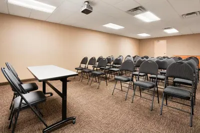 an empty room with rows of chairs in a classroom at Days Inn & Suites by Wyndham Cochrane in Cochrane