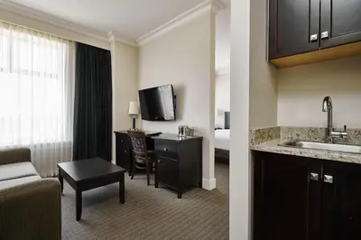 a hotel room with a kitchen and a living room at Hotel Rialto in Victoria