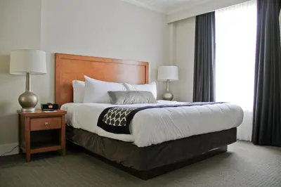 a hotel room with a large bed and a window at Hotel Rialto in Victoria