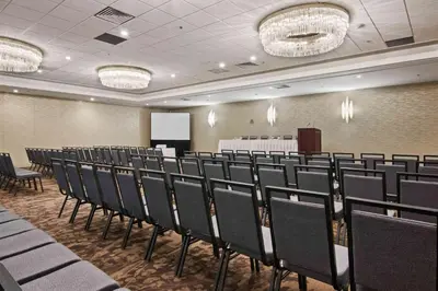 a conference room with rows of chairs and a podium at Best Western Premier Calgary Plaza Hotel & Conference Centre in Calgary