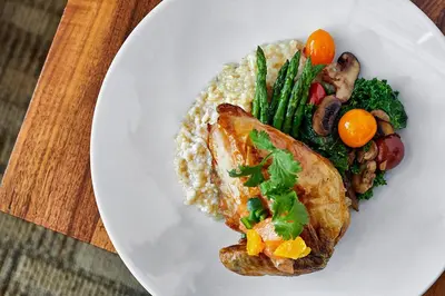 a white plate of food with rice and vegetables at The Westin Calgary in Calgary