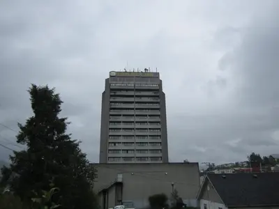 a tall building in front of a building at Highliner Hotel in Prince Rupert