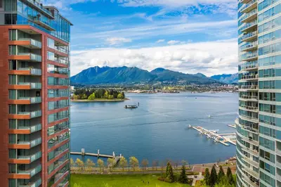 a view of a lake between two buildings at Pinnacle Hotel Harbourfront in Vancouver