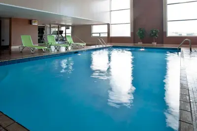 a large pool with blue water in a hotel room at Ramada Plaza by Wyndham Prince George in Prince George