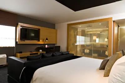 a bedroom with a large bed and a flat screen tv at Ramada Plaza by Wyndham Prince George in Prince George