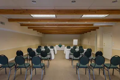 a conference room with tables and chairs in it at South Thompson Inn & Conference Centre in Kamloops
