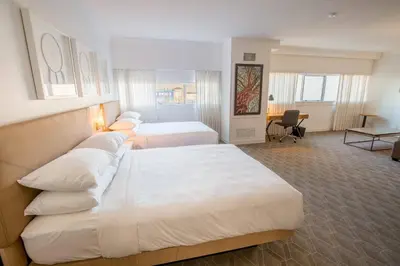 a hotel room with two beds and a desk at Delta Hotels by Marriott Kamloops in Kamloops