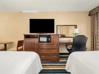 a hotel room with a desk and a television at Holiday Inn Conference Centre Edmonton South by IHG in Edmonton
