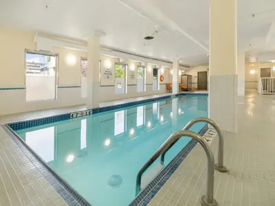 a large swimming pool in a building at Holiday Inn Conference Centre Edmonton South by IHG in Edmonton