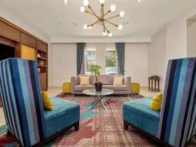 a living room with two chairs and a couch at Holiday Inn Conference Centre Edmonton South by IHG in Edmonton