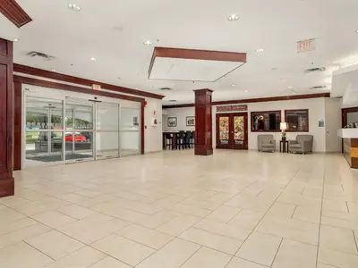 an empty lobby with a large room with glass doors at Holiday Inn Conference Centre Edmonton South by IHG in Edmonton