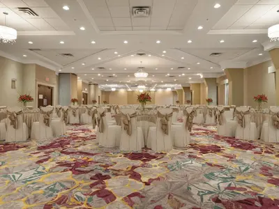a banquet hall with rows of tables and chairs at Holiday Inn Conference Centre Edmonton South by IHG in Edmonton