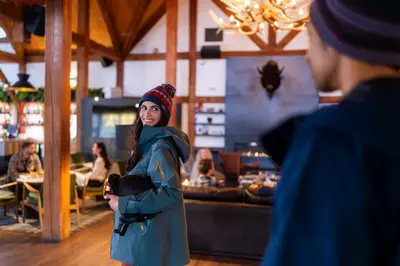 a woman standing in front of a restaurant at Buffalo Mountain Lodge in Banff