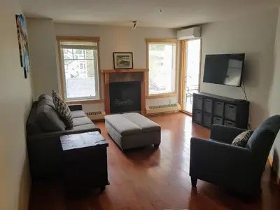 a living room with two couches and a fireplace at PRC Annex - Pet Friendly in Canmore