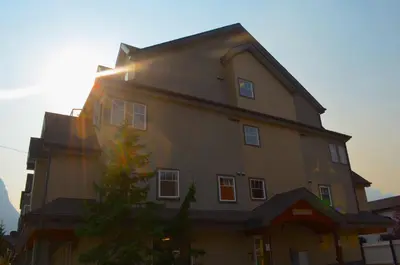 a large house with the sun shining on it at PRC Annex - Pet Friendly in Canmore
