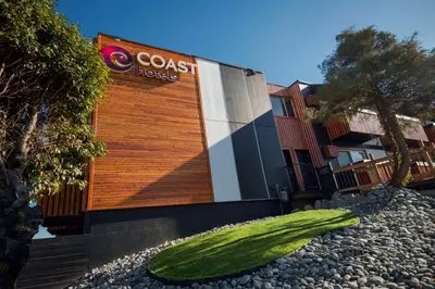 a building with a grassy object in front of it at Coast Metro Vancouver Hotel in Burnaby