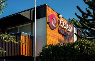 a building with a sign on the side of it at Coast Metro Vancouver Hotel in Burnaby