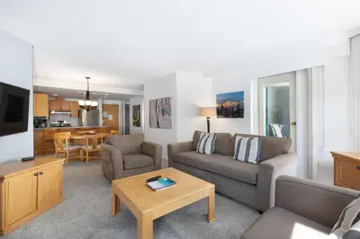 a living room with a couch and a table at The Woodrun Lodge by Whiski Jack in Whistler