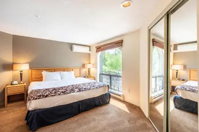 a bedroom with two beds and a large window at The Ironwood on Blueberry Hill in Whistler