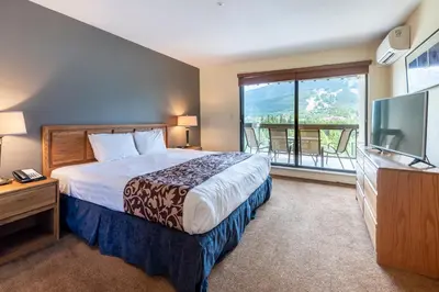 a hotel room with a bed and a television at The Ironwood on Blueberry Hill in Whistler