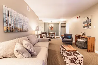 a living room with a couch and a table at Cascade Lodge by Elevate Vacations in Whistler