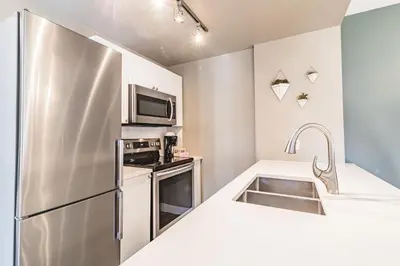 a kitchen with a stainless steel refrigerator and a sink at Cascade Lodge by Elevate Vacations in Whistler
