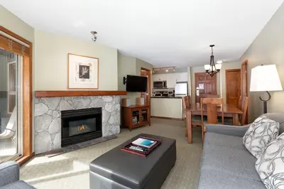 a living room with a couch and a fireplace at The Aspens by Whiski Jack in Whistler