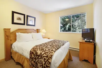 a hotel room with a bed and a television at Valhalla Vacations at Whistler in Whistler